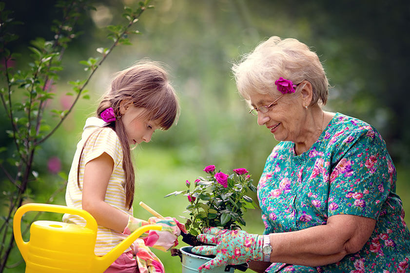 image of child and older adult holding flowers